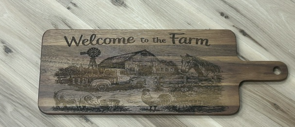 XL paddle charcuterie board engraved with Welcome to the Farm, a barn, windmill, vintage truck, and farm animals