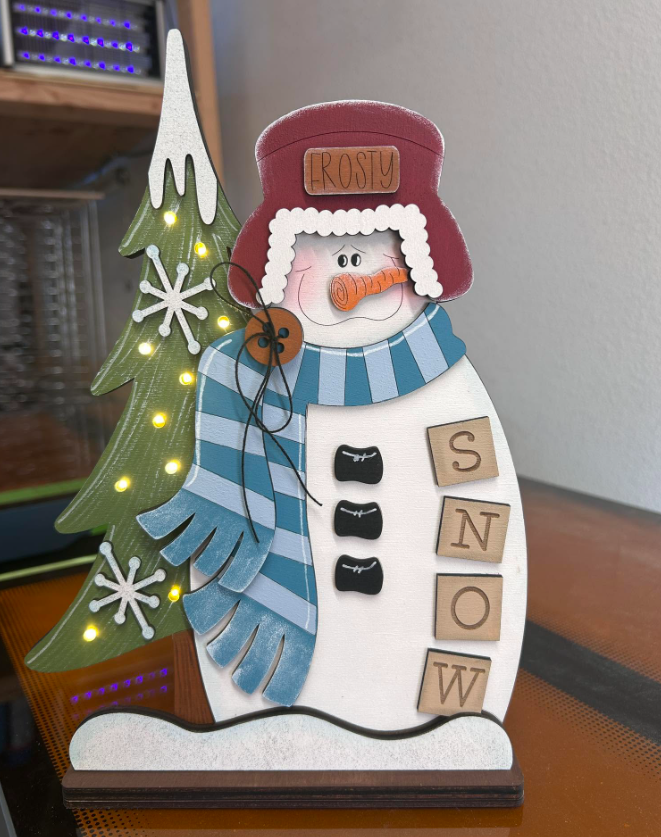 Hand-painted birch Frosty snowman shelf sitter with evergreen tree and fairy lights
