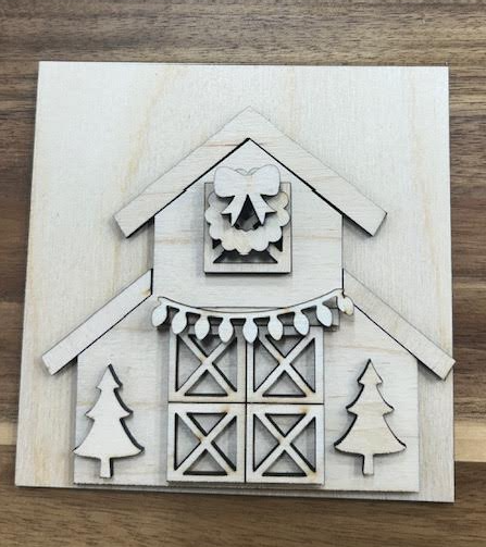 Unfinished birch Christmas barn frame insert with layered barn doors, wreath and bow, holiday lights, and two evergreen trees.