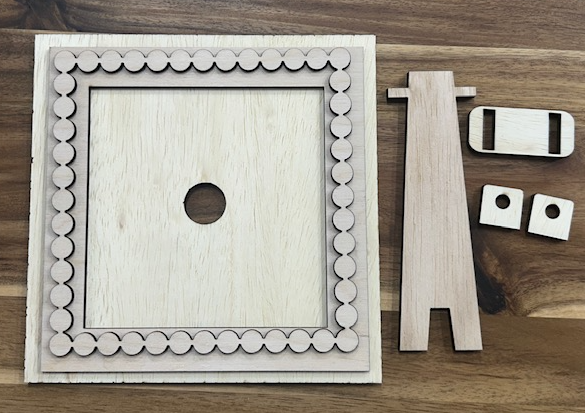 Unfinished single interchangeable birch wood frame with layered decorative border and separate stand pieces.