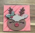 Hand-painted reindeer frame insert with a glittery red nose, holly, and brown antlers on a pink background