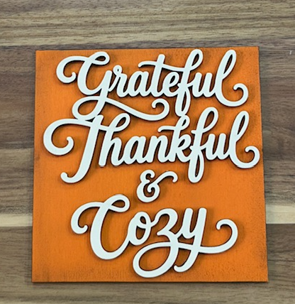 Finished orange frame insert with cream-colored Grateful Thankful & Cozy lettering