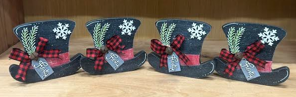 Hand painted Frosty Hat holiday decor - set of four showing dark background with plaid bows, snowflakes, and greenery accents