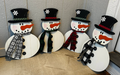Hand-painted birch snowman door hangers with shiplap background, black hats, and fabric scarves