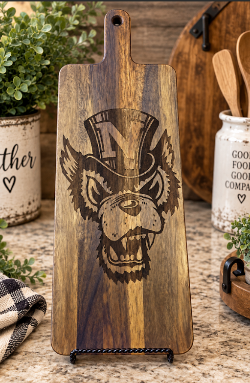 Extra large acacia paddle charcuterie board with a laser-engraved wolf wearing a top hat