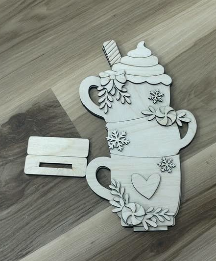 Unfinished stacked hot cocoa mugs birch wood shelf sitter blank with layered peppermint, greenery, snowflake details, and separate base pieces.