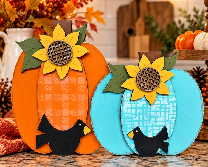 Finished orange and turquoise pumpkin shelf sitter with yellow sunflowers, green leaves, and black birds