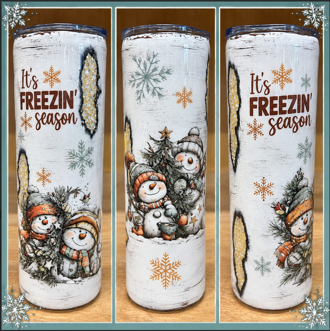 White 20oz skinny epoxy tumbler with bundled-up snowmen, snowflakes, and It's Freezin Season design