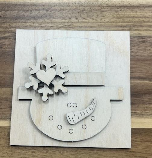 Unfinished snowman frame insert wood blank with a top hat, snowflake, heart, and carrot nose